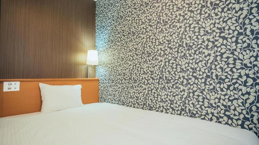 Bed in Hotel AreaOne Miyazaki City