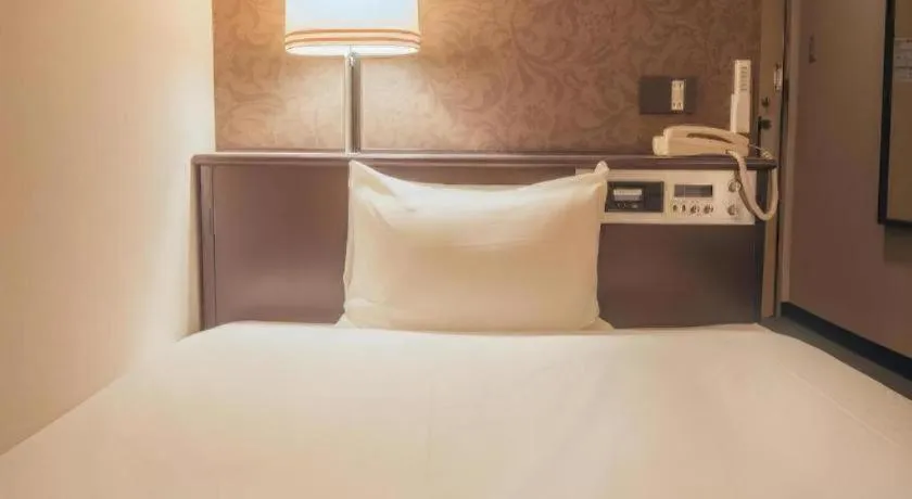 Bed in Hotel AreaOne Miyazaki City