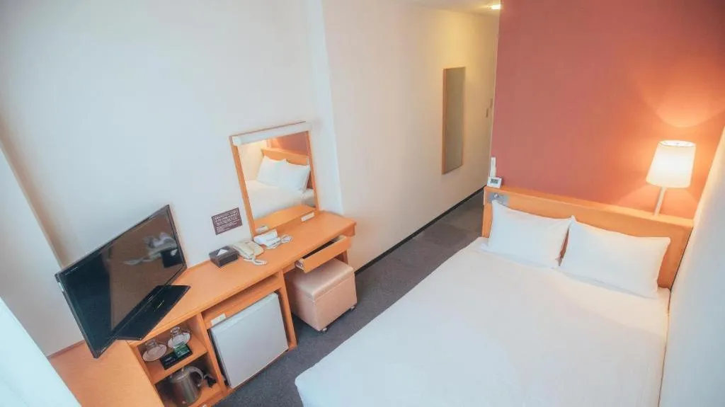 Bed in Hotel AreaOne Miyazaki City