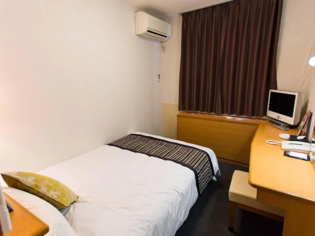 Bed in Hotel AreaOne Miyazaki City