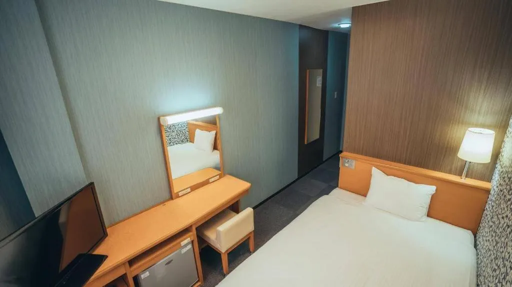 Bed in Hotel AreaOne Miyazaki City