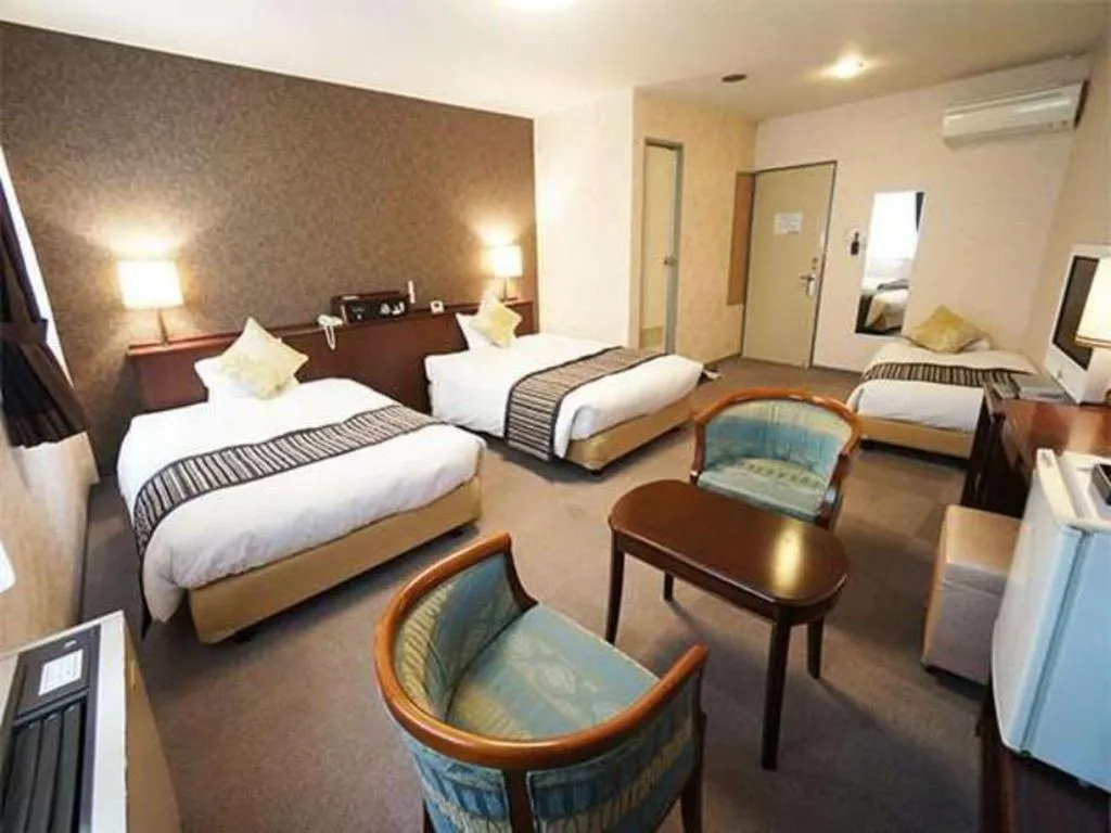 Bed in Hotel AreaOne Miyazaki City