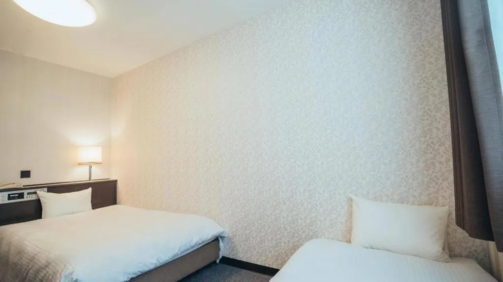 Bed in Hotel AreaOne Miyazaki City