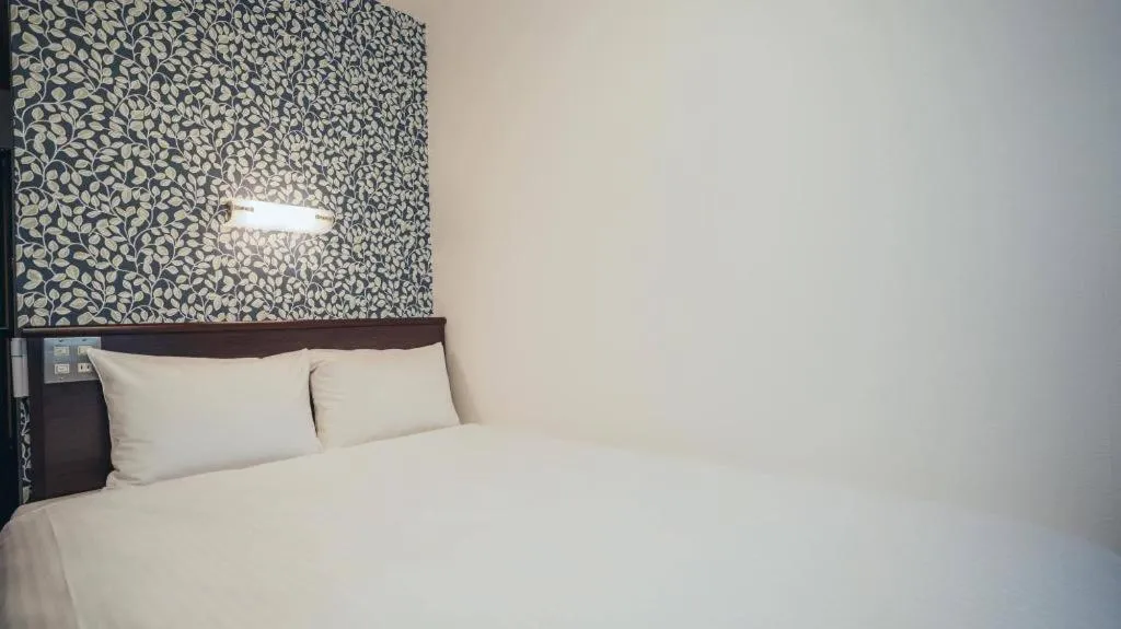 Bed in Hotel AreaOne Miyazaki City