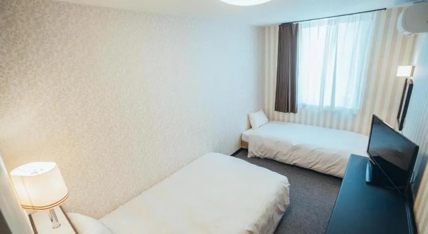 Bed in Hotel AreaOne Miyazaki City