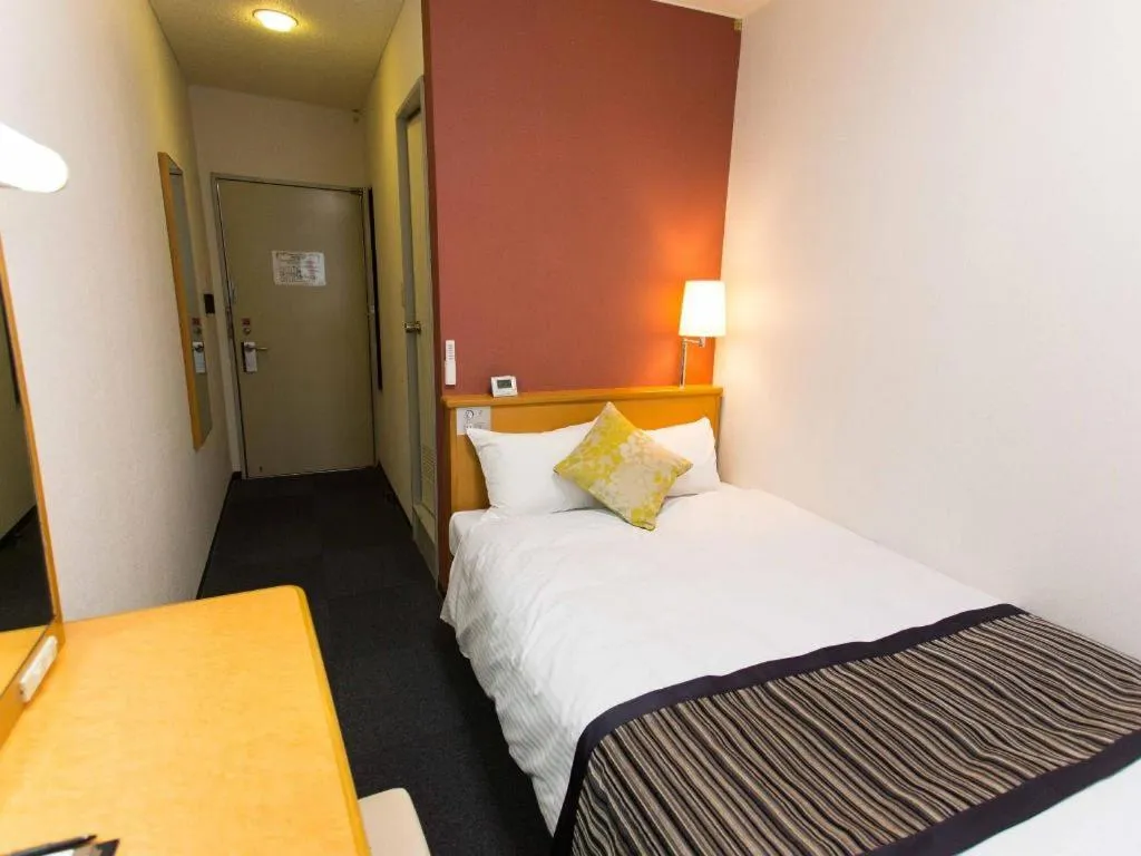 Bed in Hotel AreaOne Miyazaki City