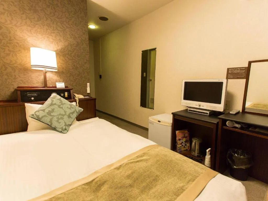 Bed in Hotel AreaOne Miyazaki City