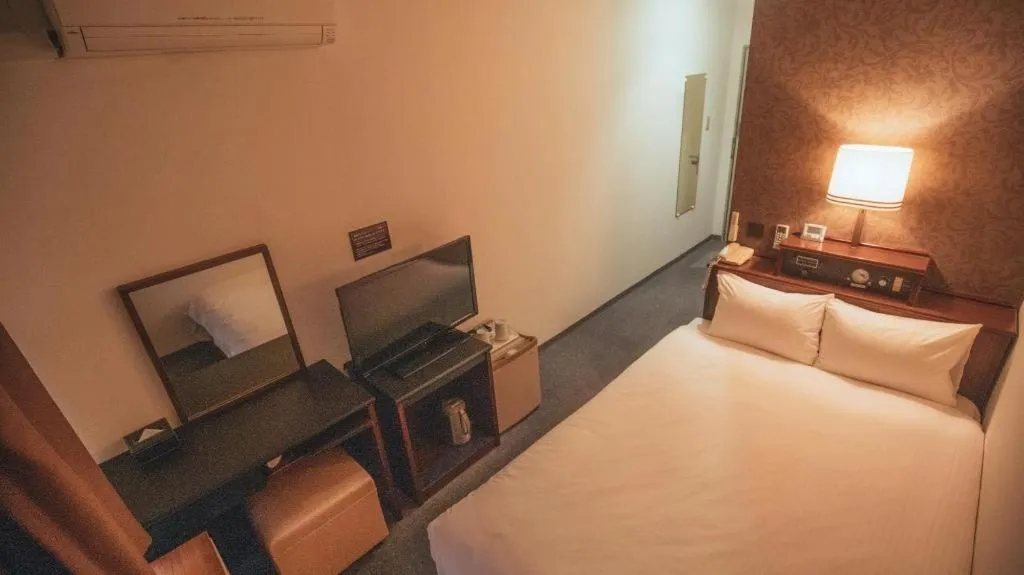 Bed in Hotel AreaOne Miyazaki City