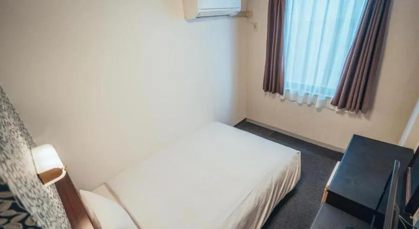 Bed in Hotel AreaOne Miyazaki City
