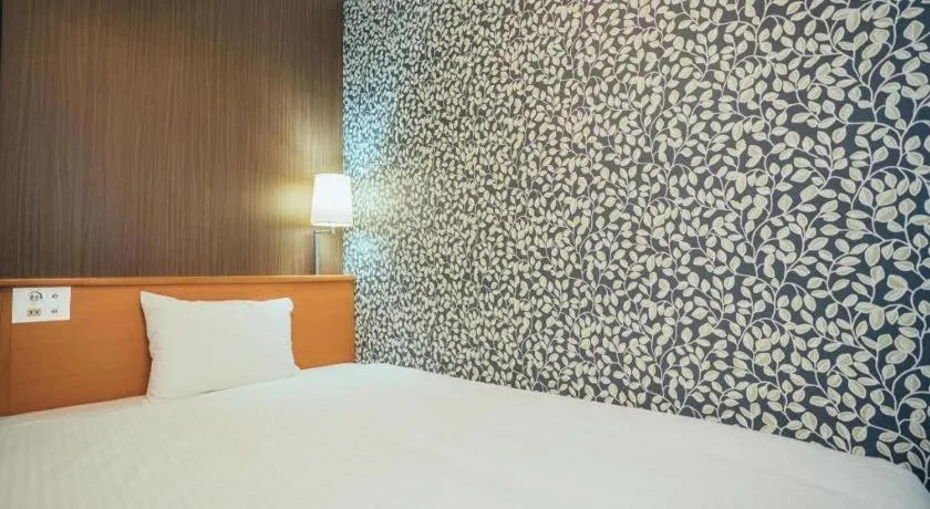 Bed in Hotel AreaOne Miyazaki City