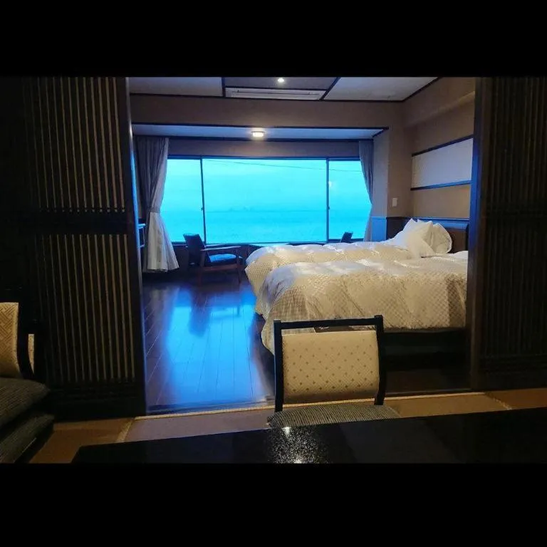 Bed in Shinojima Royal Hotel Kasuisou