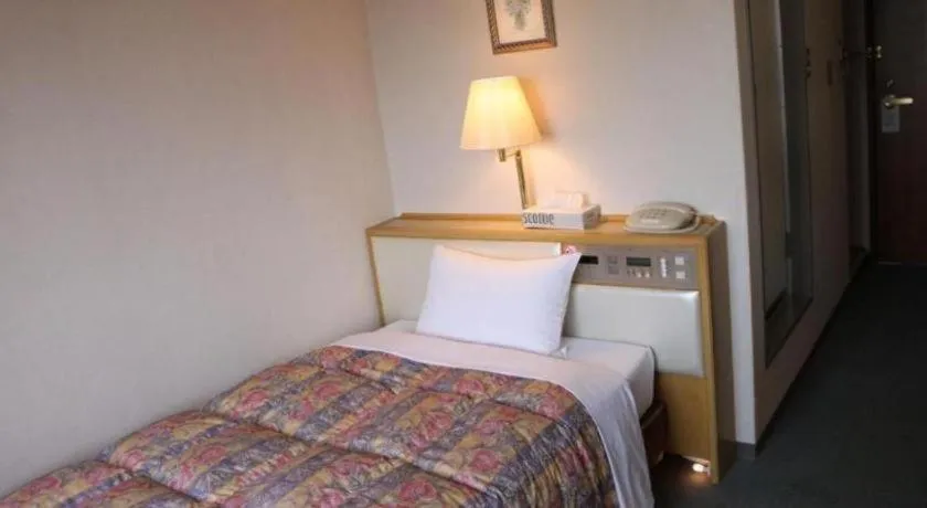 Bed in Palace Inn Toyota