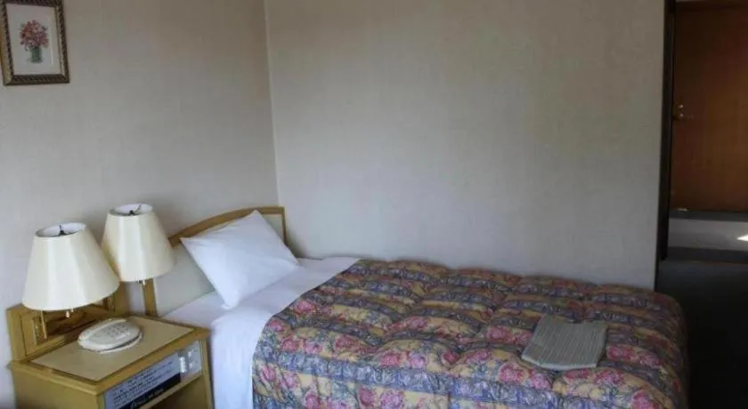 Bed in Palace Inn Toyota