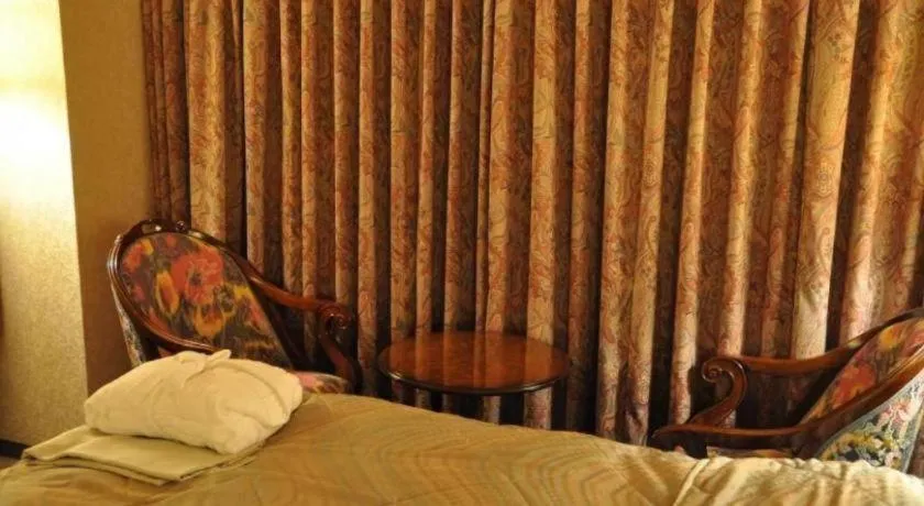 Bed in Palace Inn Toyota