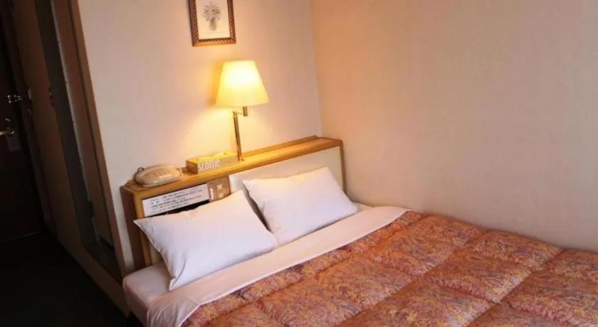 Bed in Palace Inn Toyota