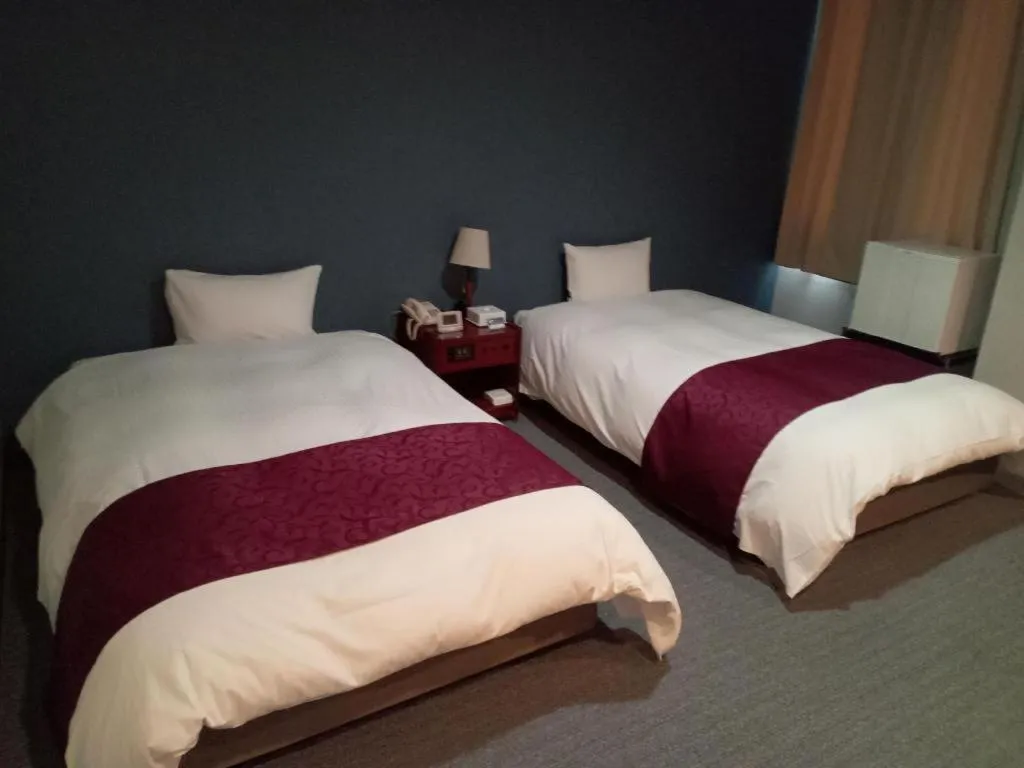 Bed in AKISAWA HOTEL