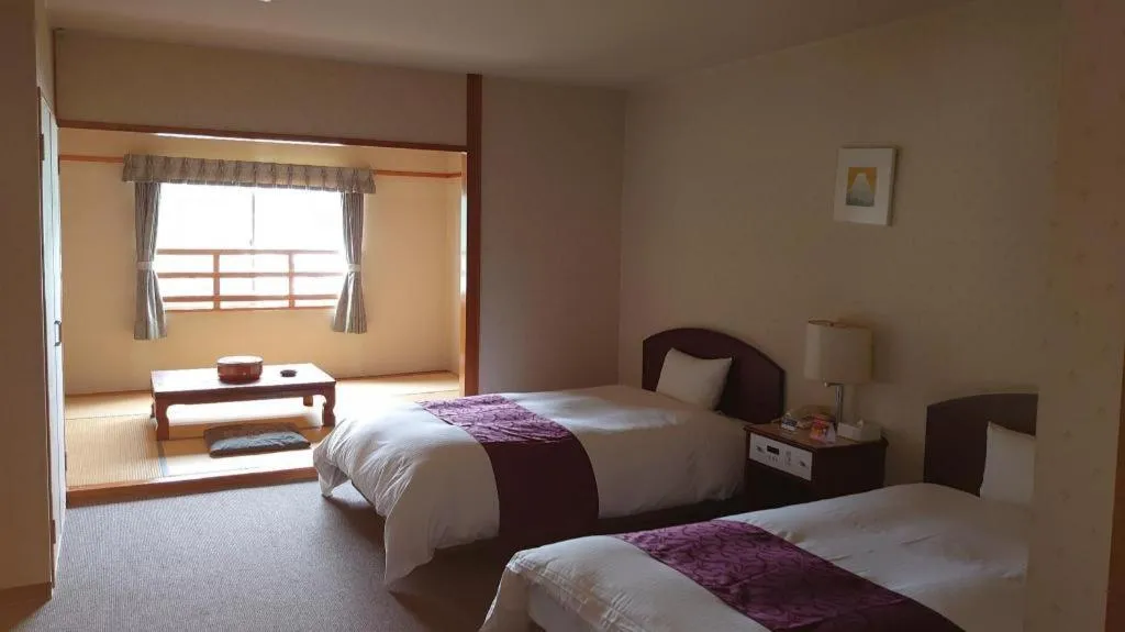 Bed in AKISAWA HOTEL