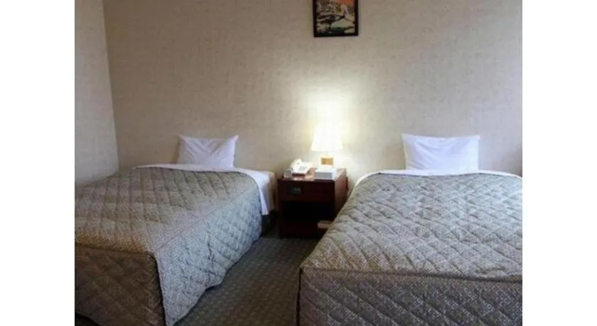 Bed in AKISAWA HOTEL