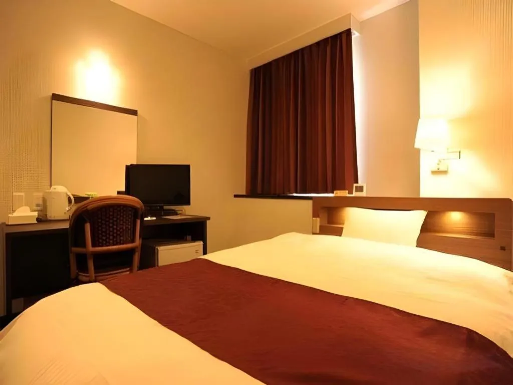 Bed in AKISAWA HOTEL