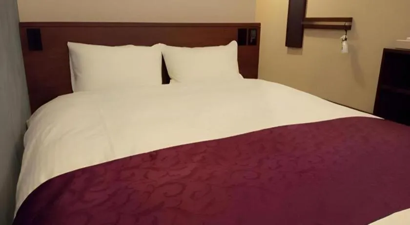 Bed in AKISAWA HOTEL