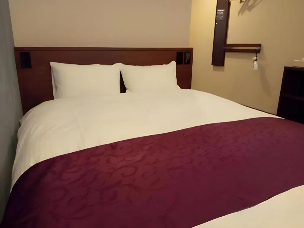 Bed in AKISAWA HOTEL