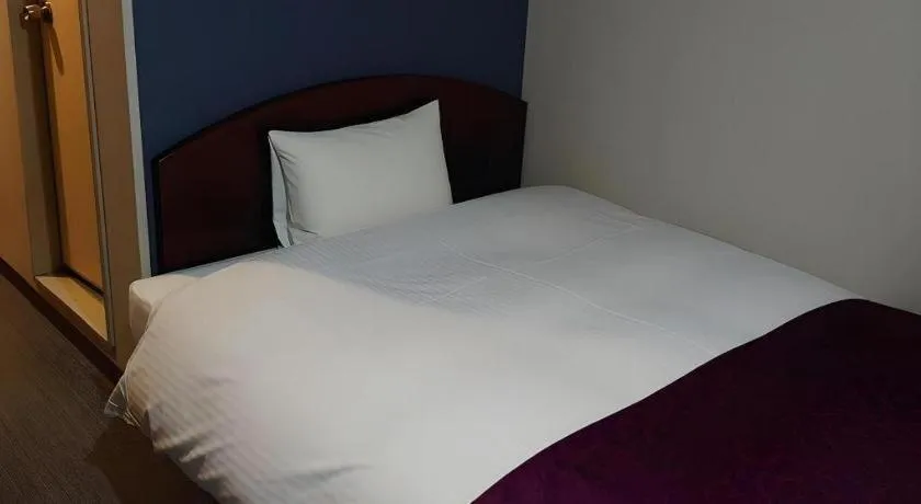 Bed in AKISAWA HOTEL