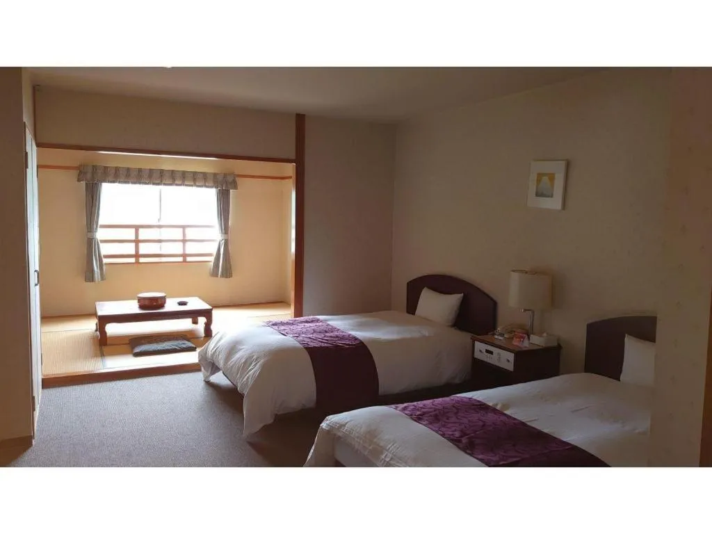 Bed in AKISAWA HOTEL