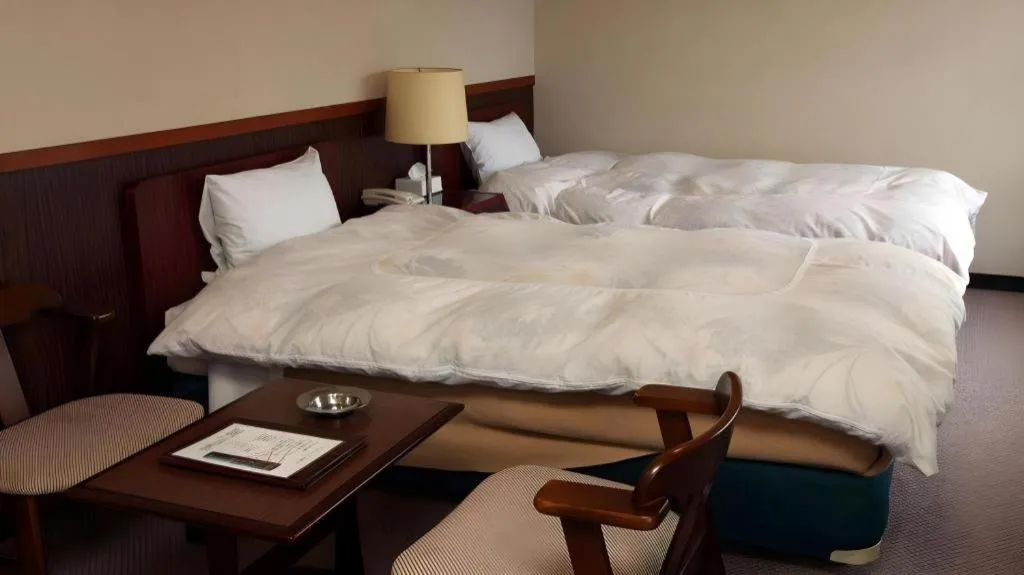 Bed in AKISAWA HOTEL