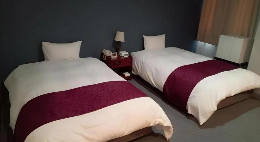 Bed in AKISAWA HOTEL