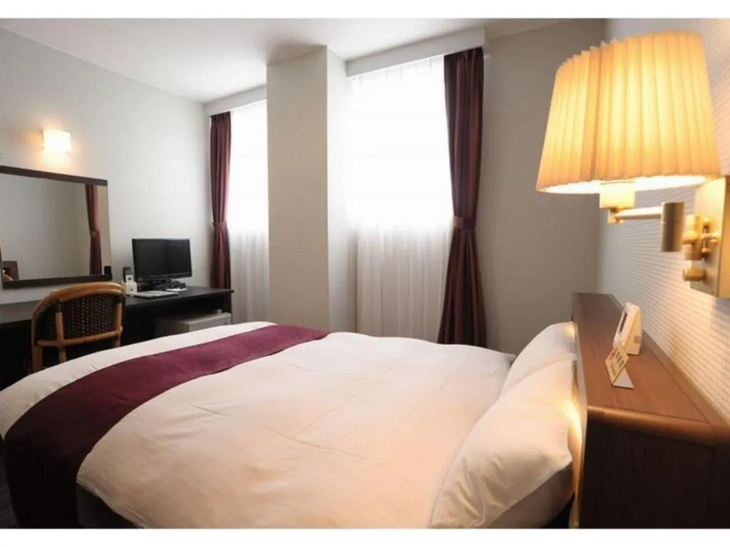 Bed in AKISAWA HOTEL