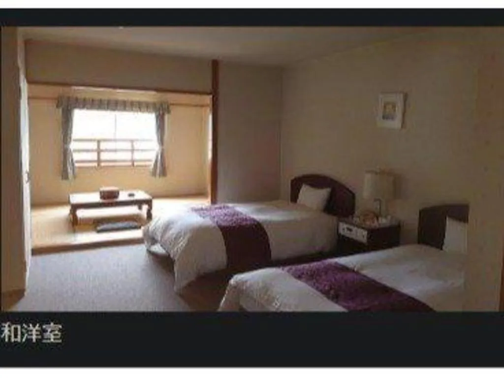 Bed in AKISAWA HOTEL