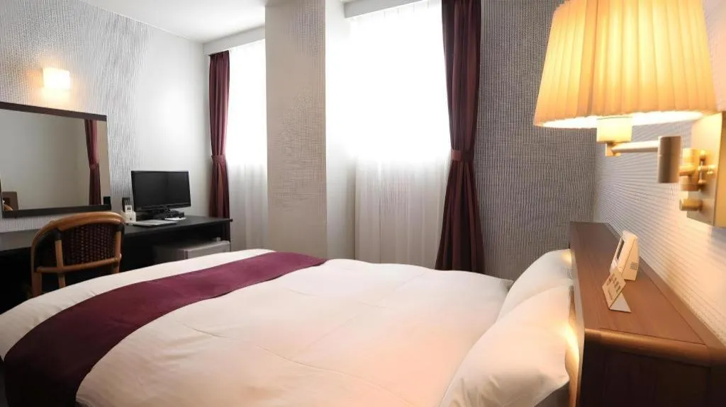 Bed in AKISAWA HOTEL