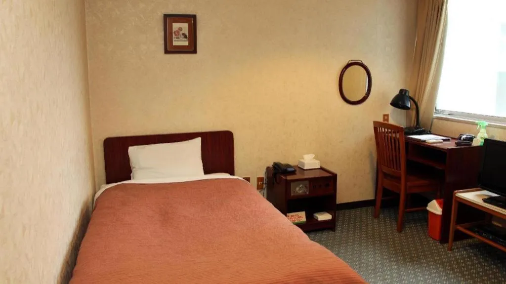 Bed in AKISAWA HOTEL