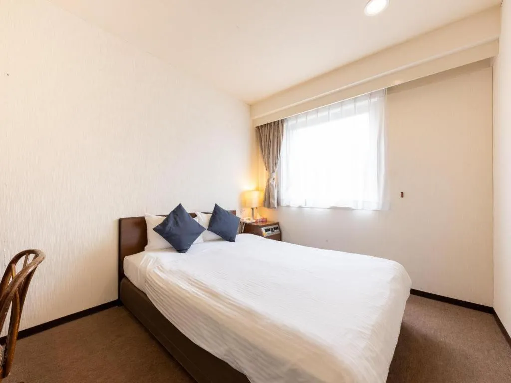 Bed in Tabist Yabuki Station Hotel