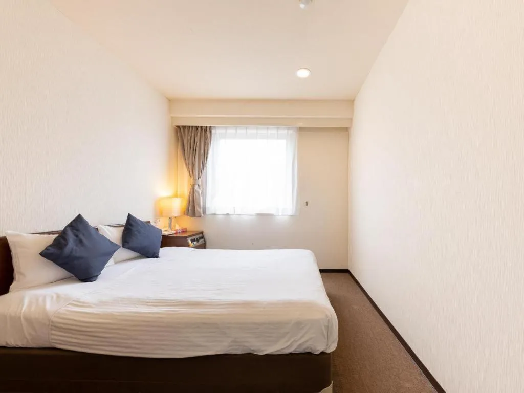 Bed in Tabist Yabuki Station Hotel