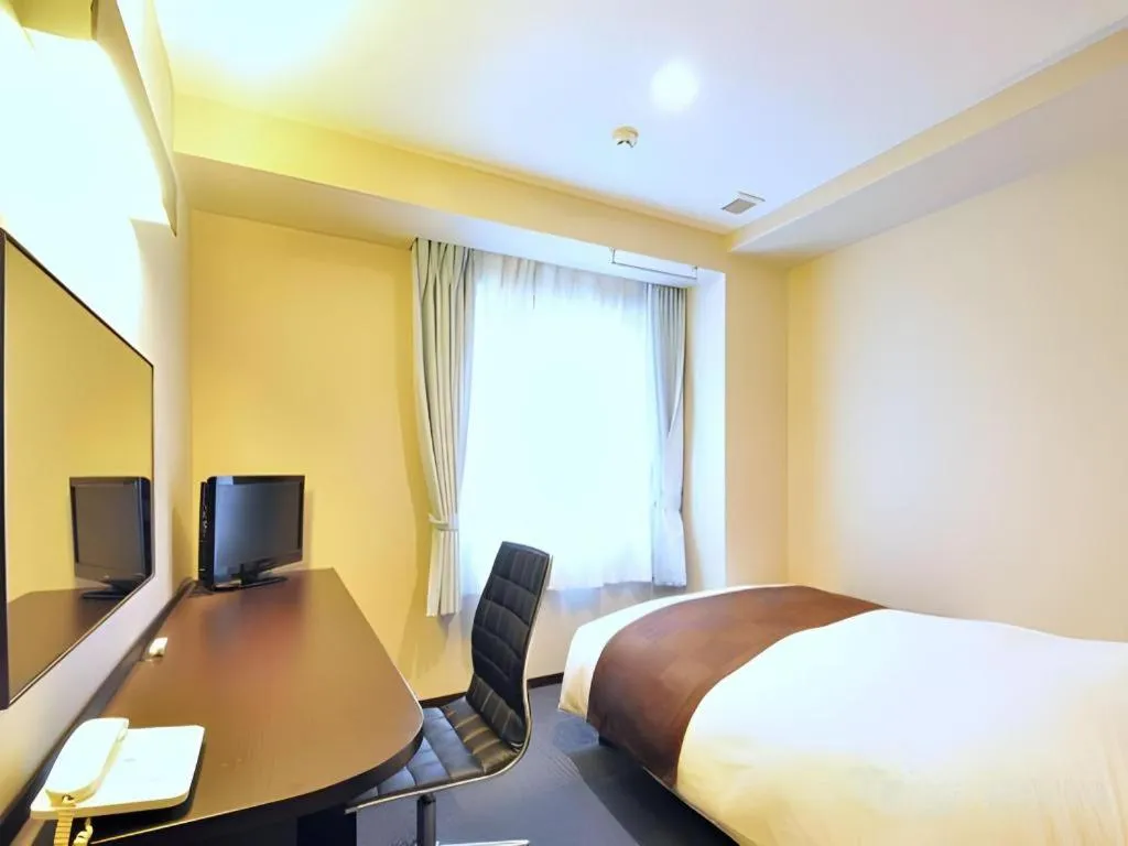 Bed in Hotel New Amami