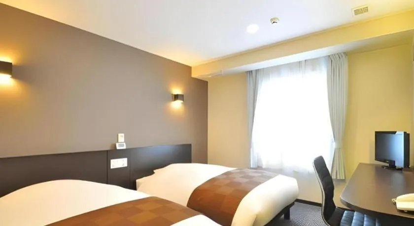 Bed in Hotel New Amami