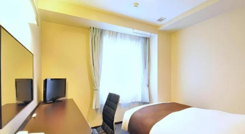 Bed in Hotel New Amami