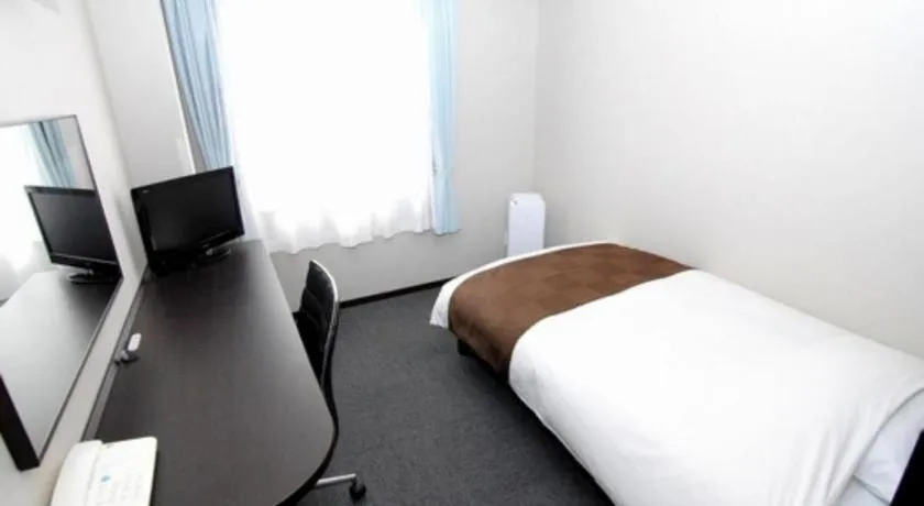 Bed in Hotel New Amami