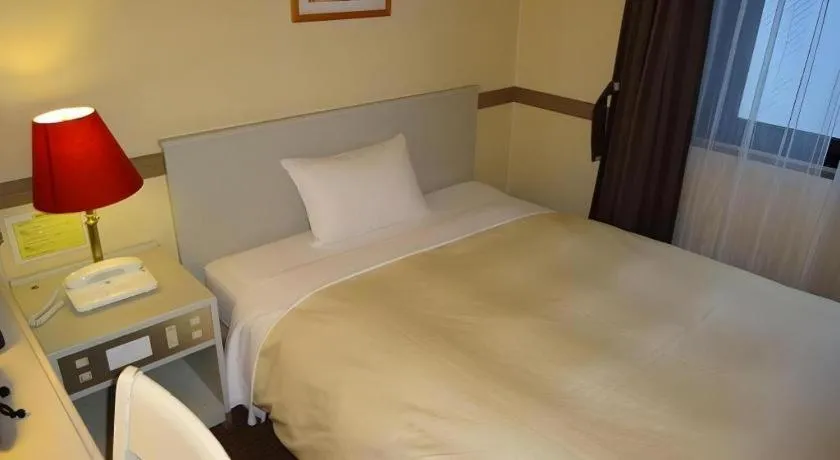 Bed in Matsumoto Wellton Hotel