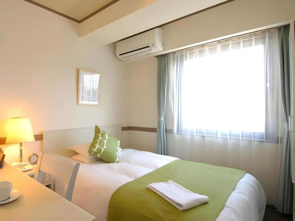 Bed in Matsumoto Wellton Hotel