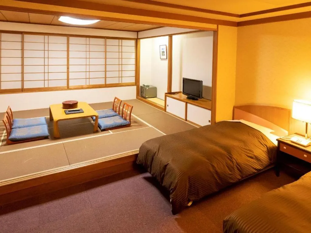 Bed in Oze Iwakura Resort Hotel