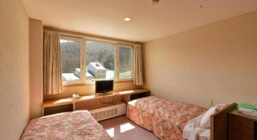 Bed in Oze Iwakura Resort Hotel