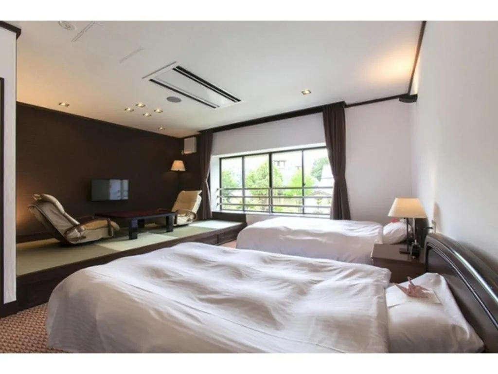 Bed in Hotel Silk Onsen Yamabiko