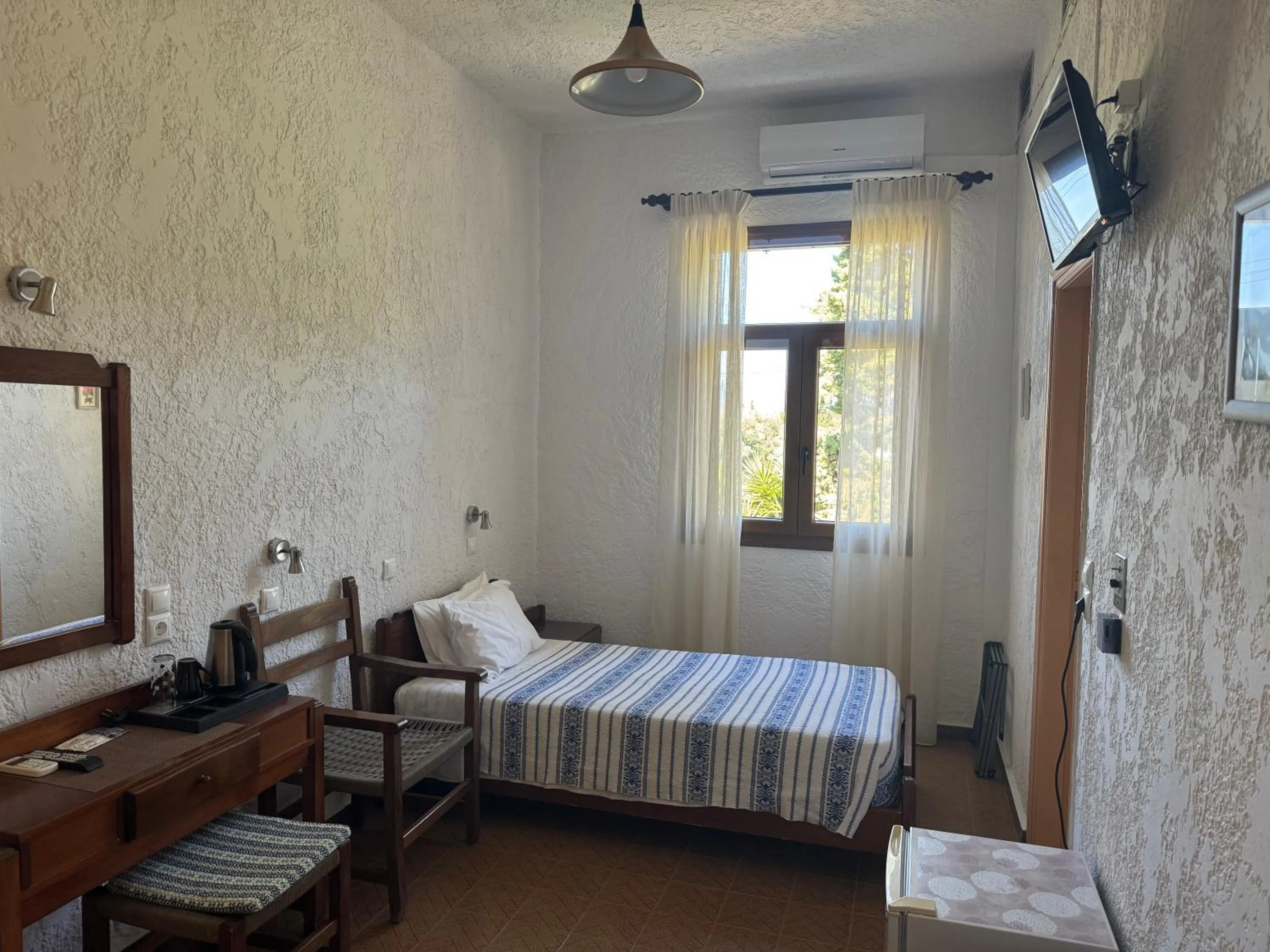 Bed in Pythaïs Hotel