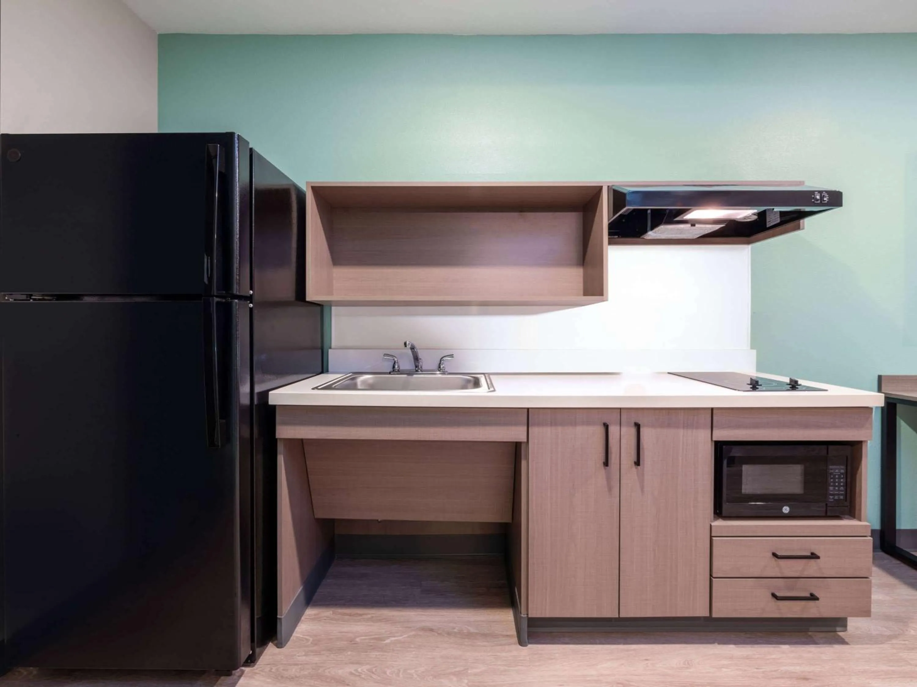 Kitchen or kitchenette in ECHO Suites Extended Stay by Wyndham Indianapolis AmeriPlex