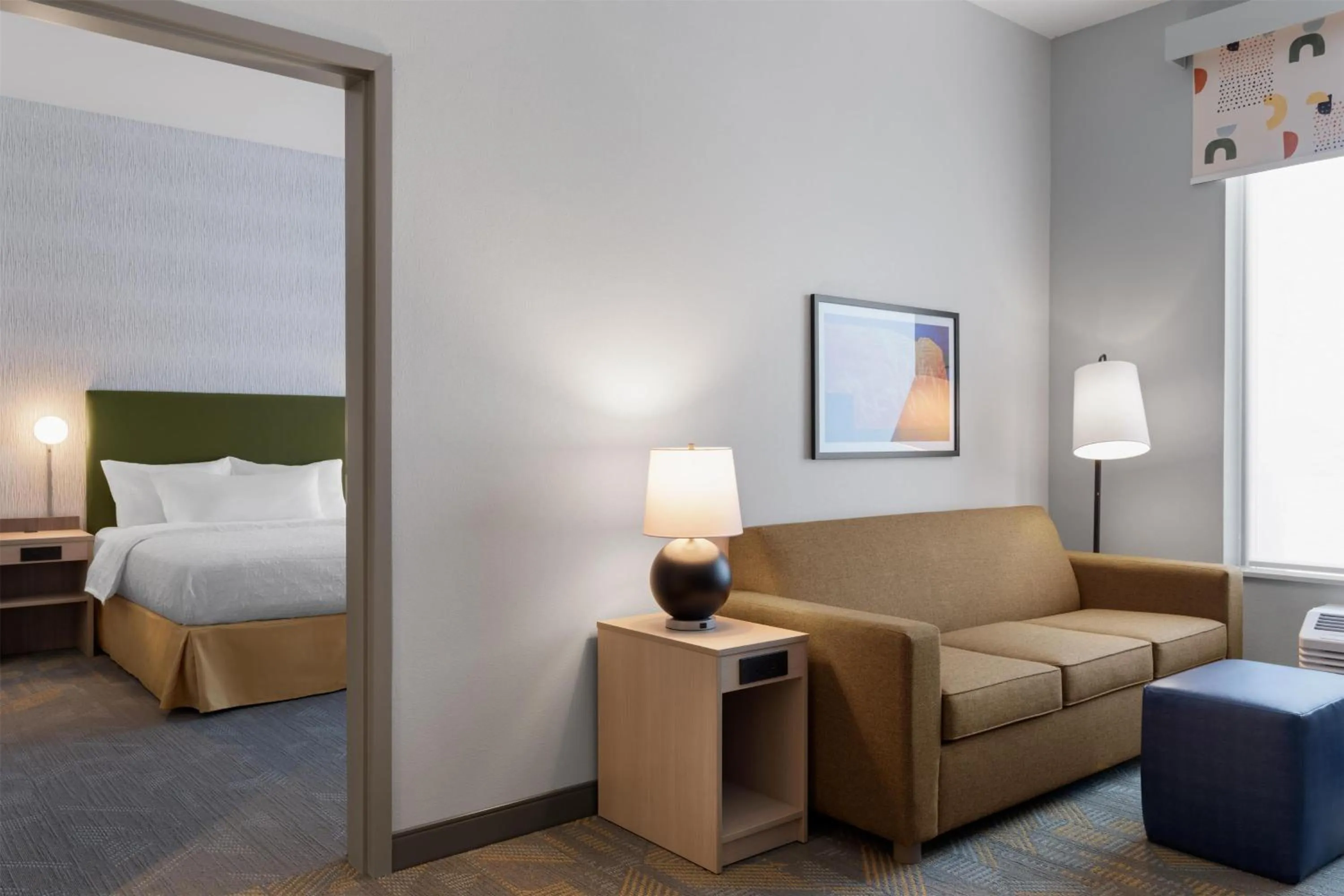 Living room, Bed in Home2 Suites By Hilton Kearney