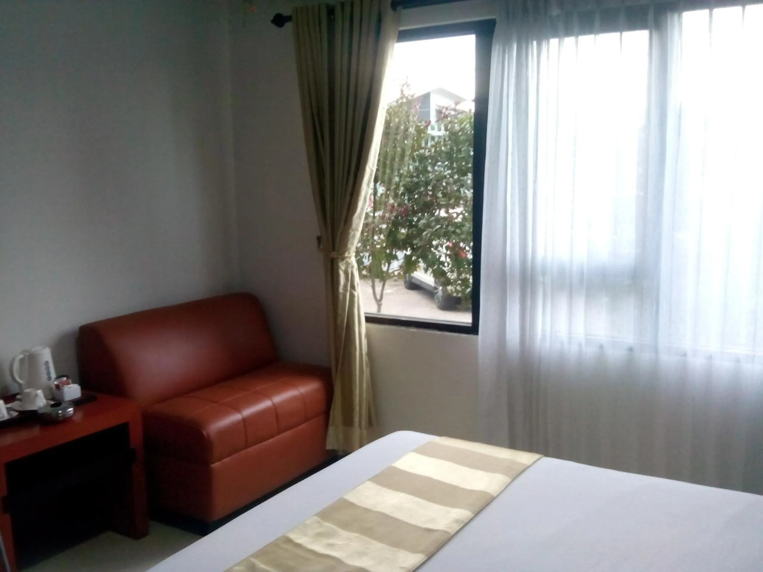 Seating area, Bed in Hotel Grand Karawang Indah