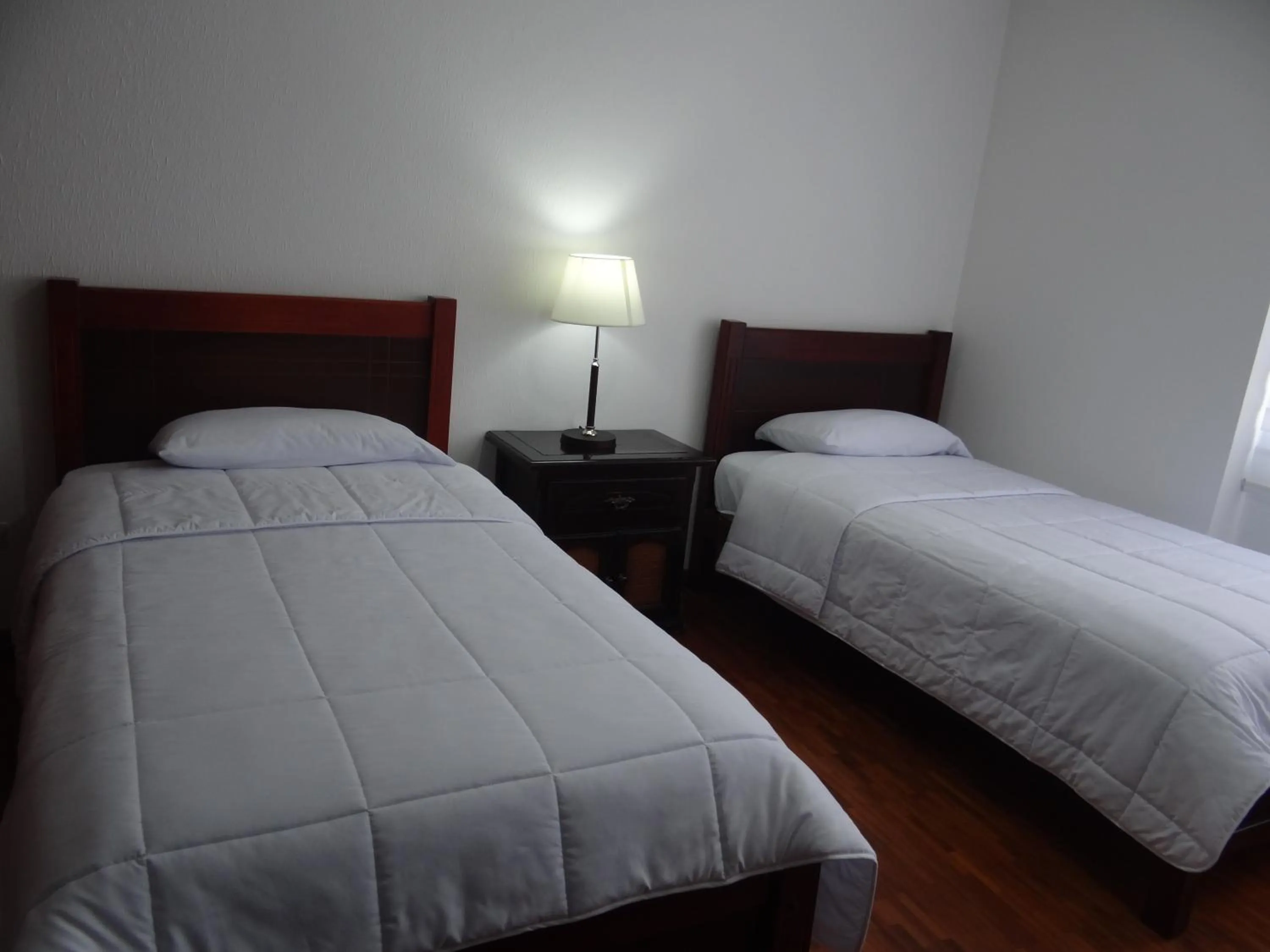 Bed in Altura Rooms & Suites