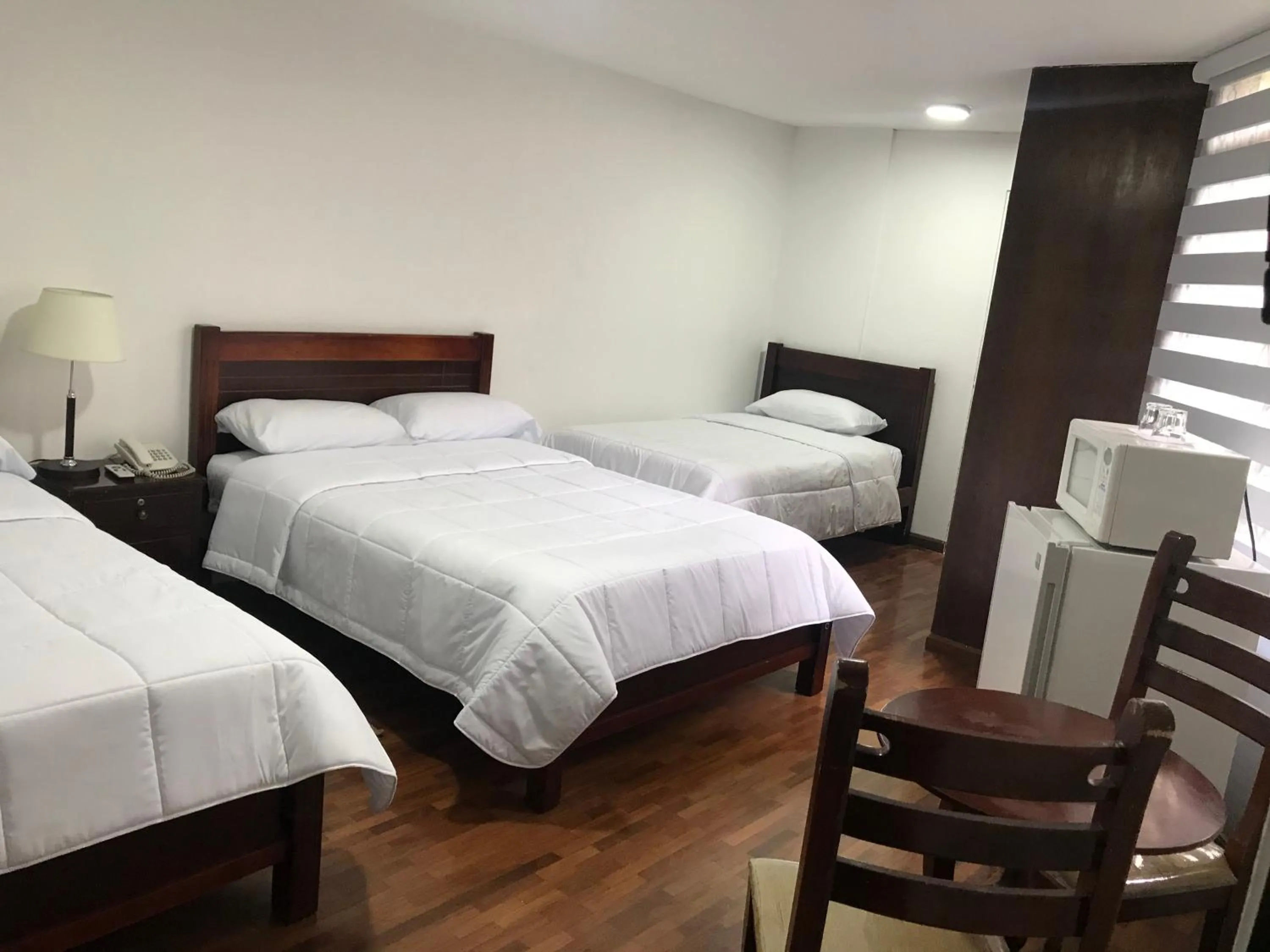 Bed in Altura Rooms & Suites
